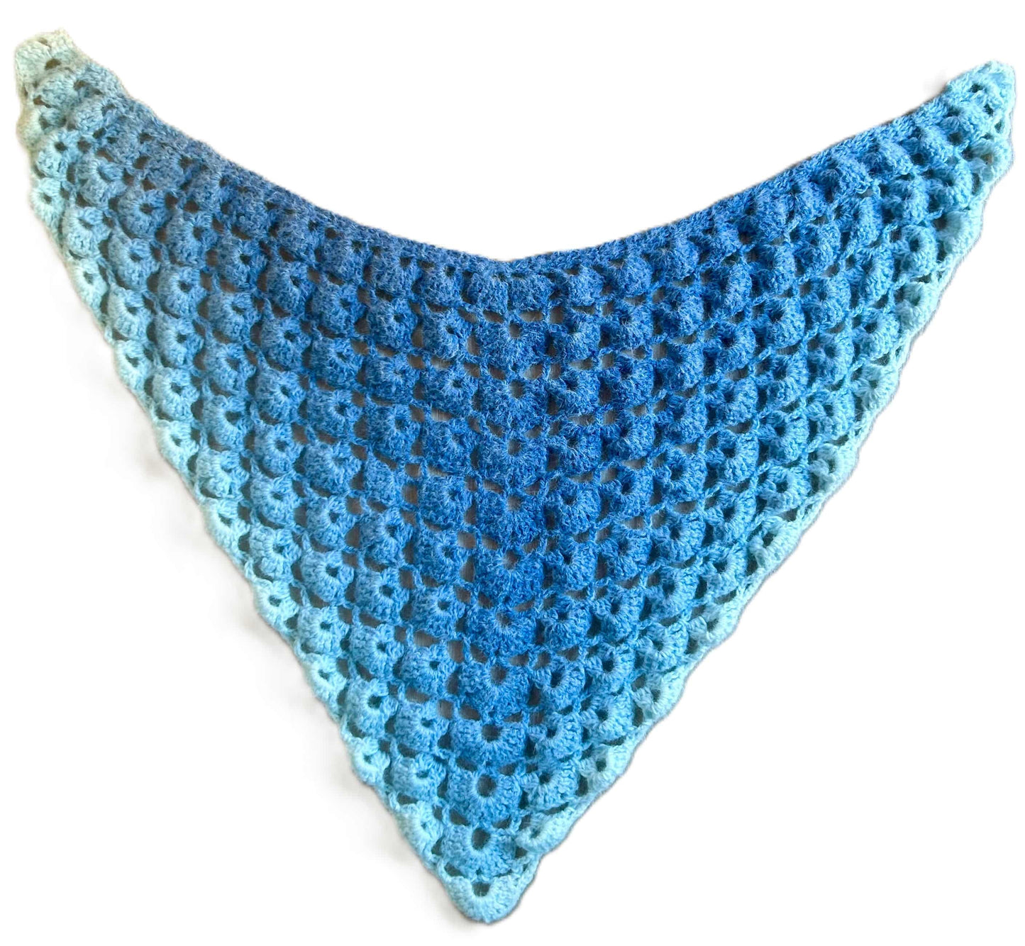 Closeup of a light blue crocheted cozy ombre shawl
