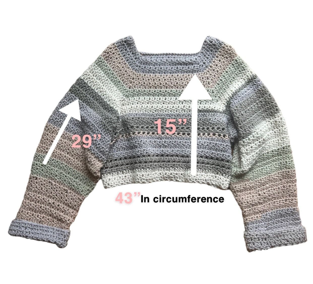 Measurements of a striped crocheted cropped sweater and ripped jeans near a window.