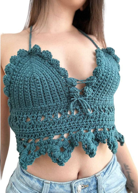 A photo of a person wearing a handmade bella crochet halter top that is green in color